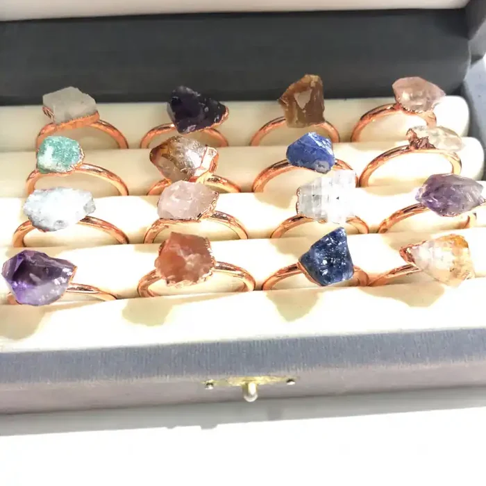 16 Raw Gemstones in copper rings Br 2446